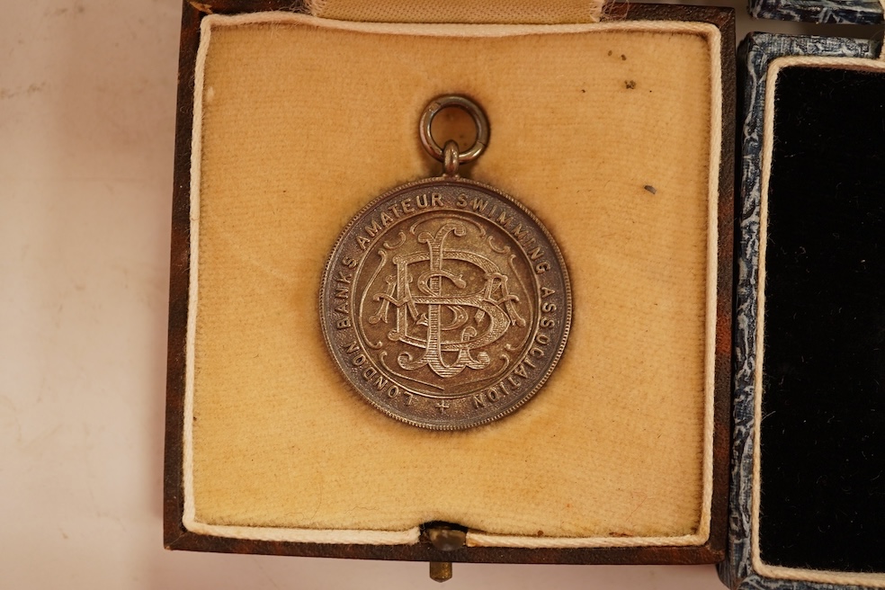 A quantity of assorted silver life-saving and swimming medals, early 20th century, cased